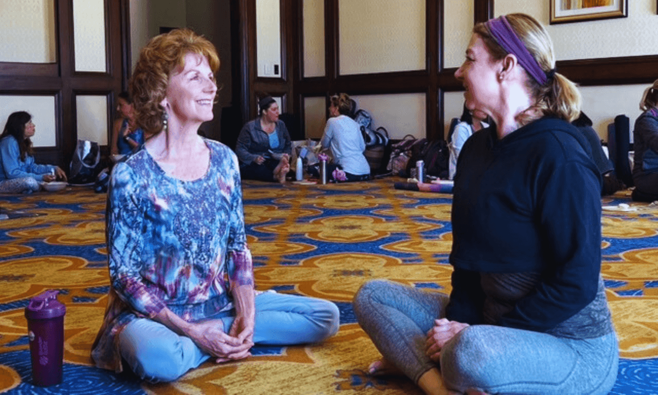Cindy Baez connecting one-on-one with a woman at a retreat